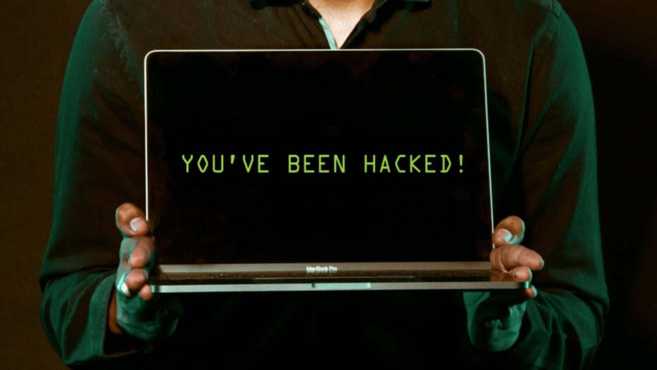 Man holding a laptop that says you