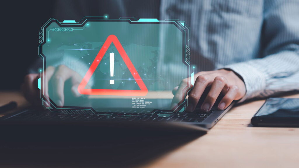 man using a laptop with a hologram show app interface with warning