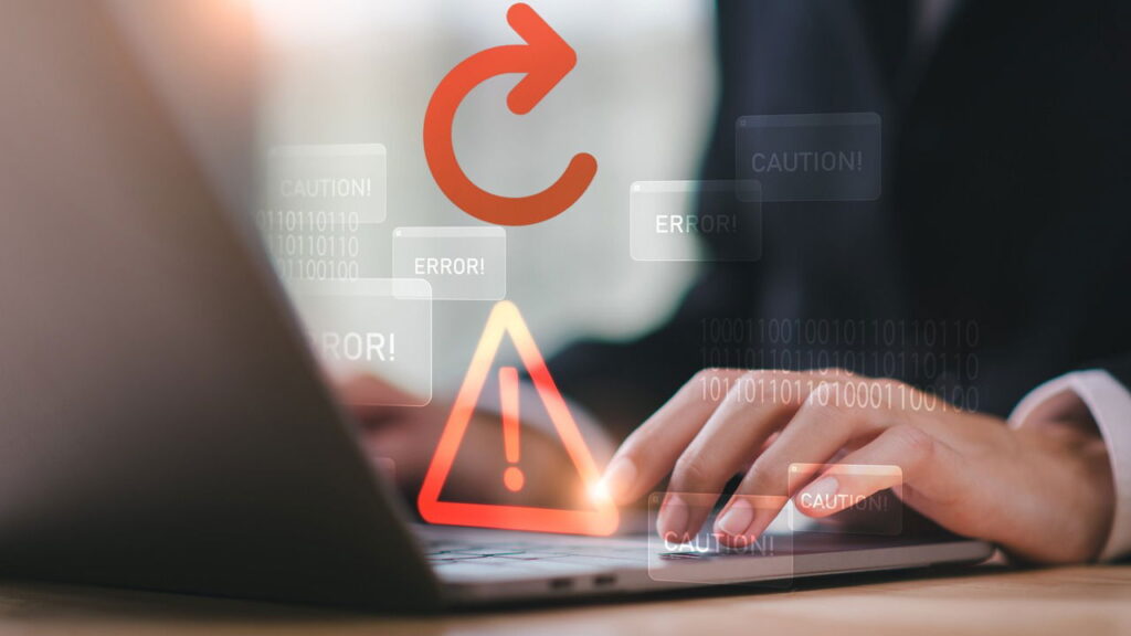 Man working on laptop with errors and caution signs