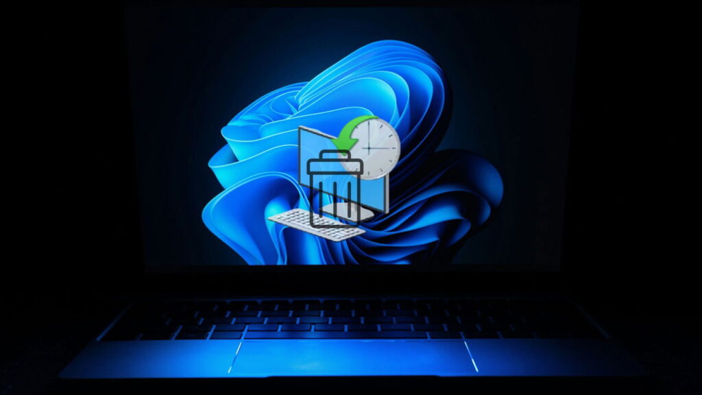 Windows 11 on a laptop in dark with System Restore icon
