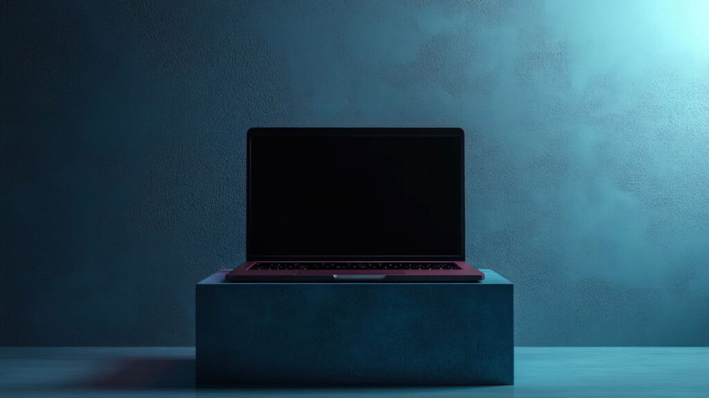 Red laptop with display off with a blue background