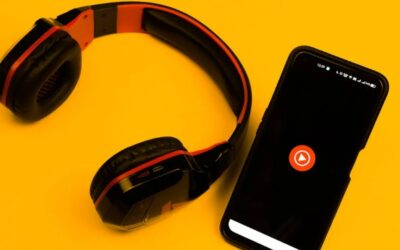 YouTube Music icon on phone beside headphones on a yellow background.