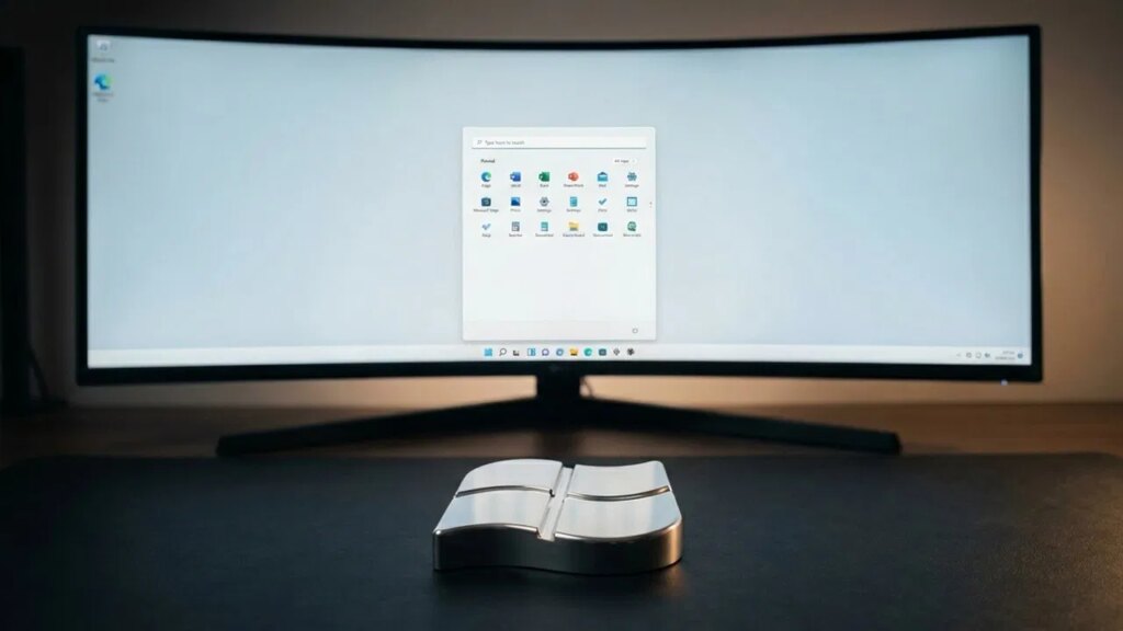 A curved display with a clean Windows 11 Start Menu open with ony pinned items showing