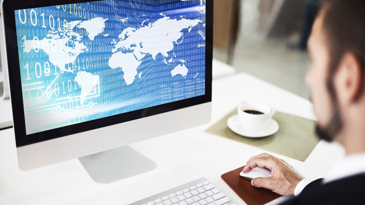 Man working on PC with earth globe and binary numbers on it